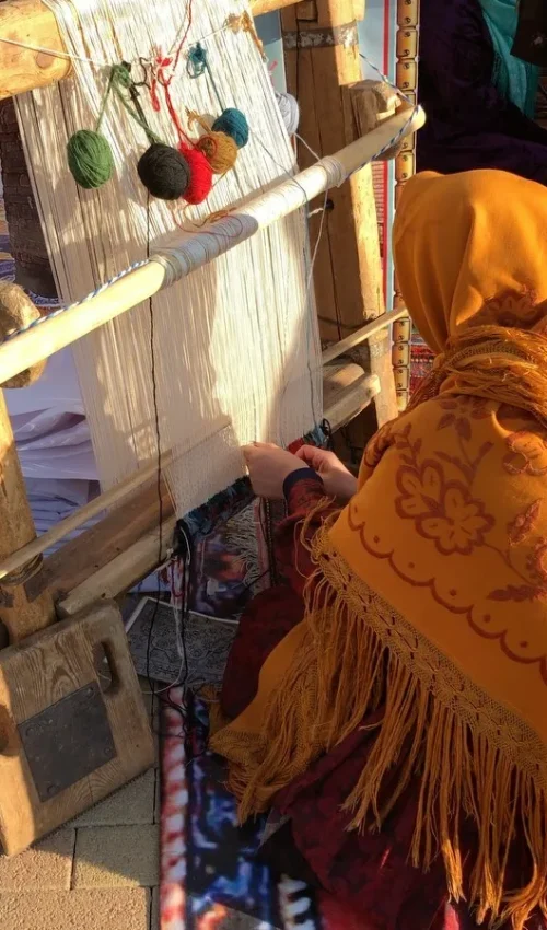 Moroccan woman making rugs